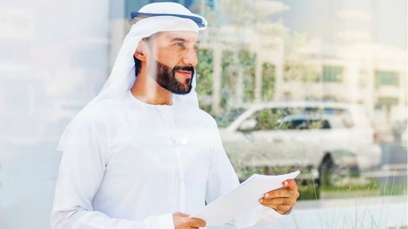 Dubai businessman holding paper regulations