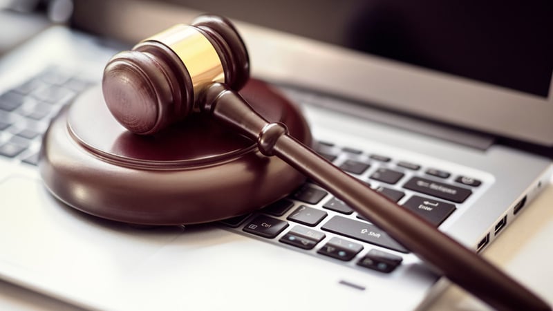 Law gavel sitting on top of laptop